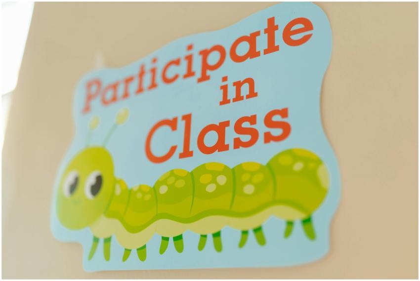A brightly colored sign encouraging class particip