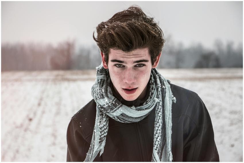 Portrait of a young man outdoors in a snowy field
