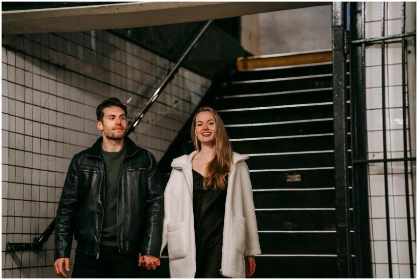 Cheerful couple in casual clothes holding hands an