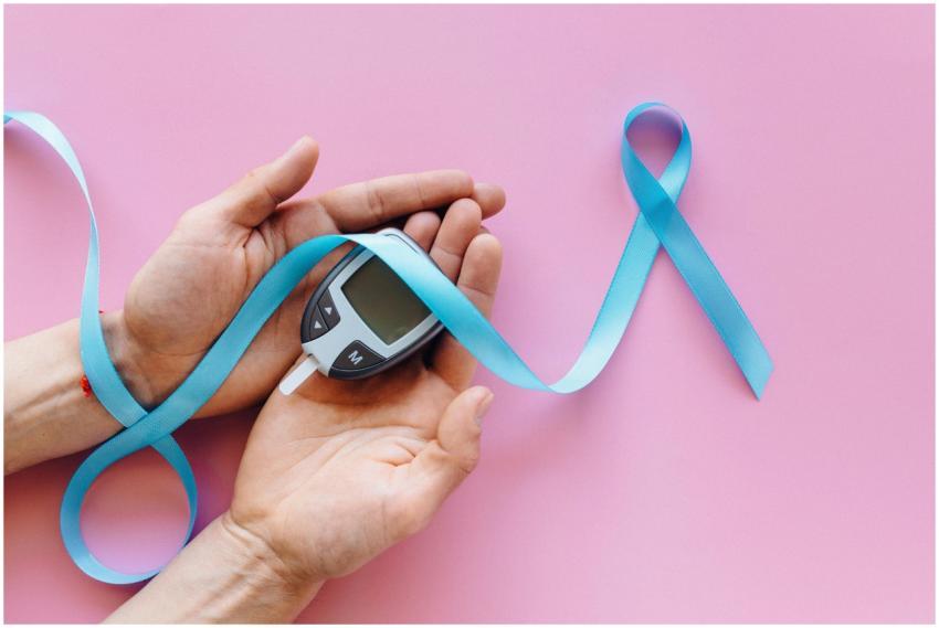 A close-up image of hands holding a glucometer wit
