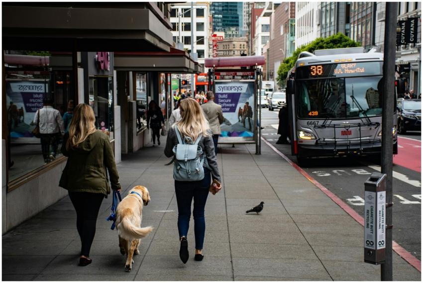 People walking on a bustling city sidewalk with a