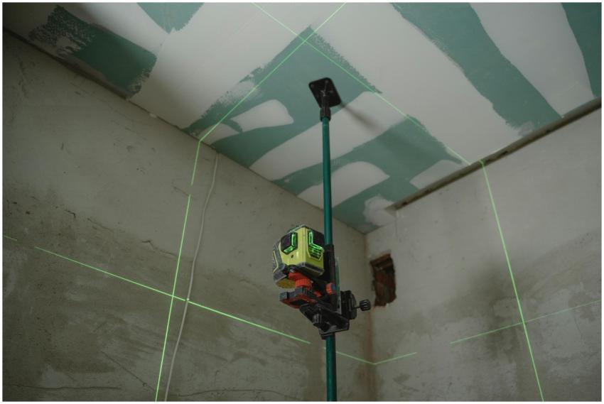 A laser level tool in action at an indoor construc
