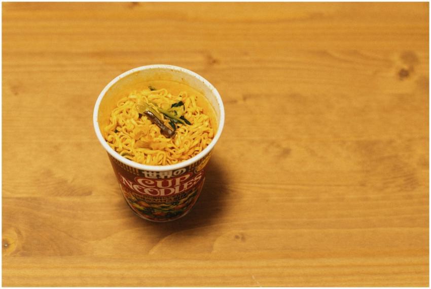 Close-up of a cup noodle on a wooden table, tradit