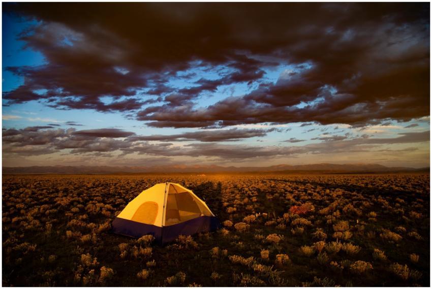 A vibrant sunset over a campsite in the Colorado d