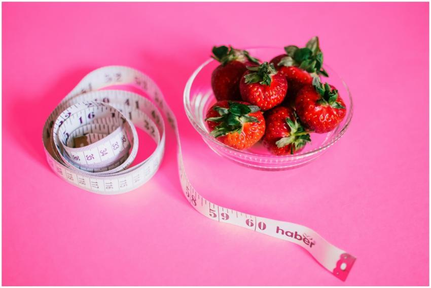 A glass bowl of fresh strawberries paired with a p