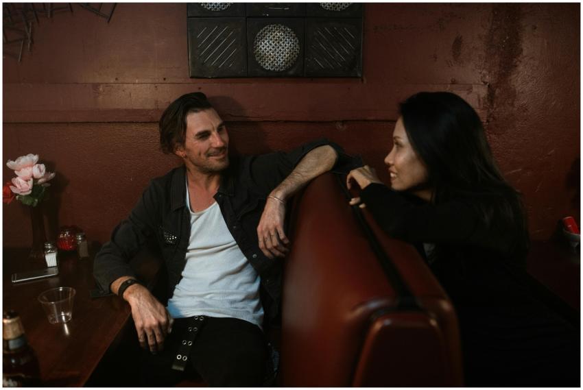 Two friends enjoying a relaxed conversation in a c