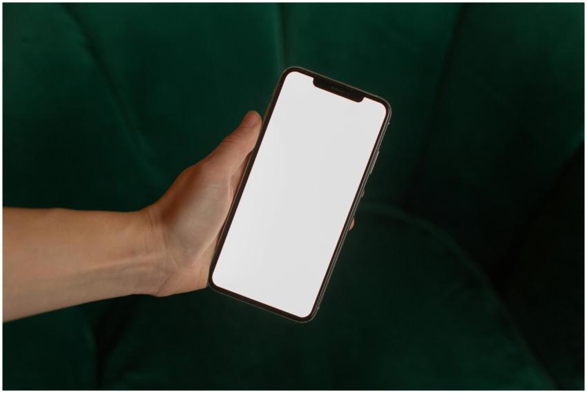 A close-up of a hand holding a smartphone with a b