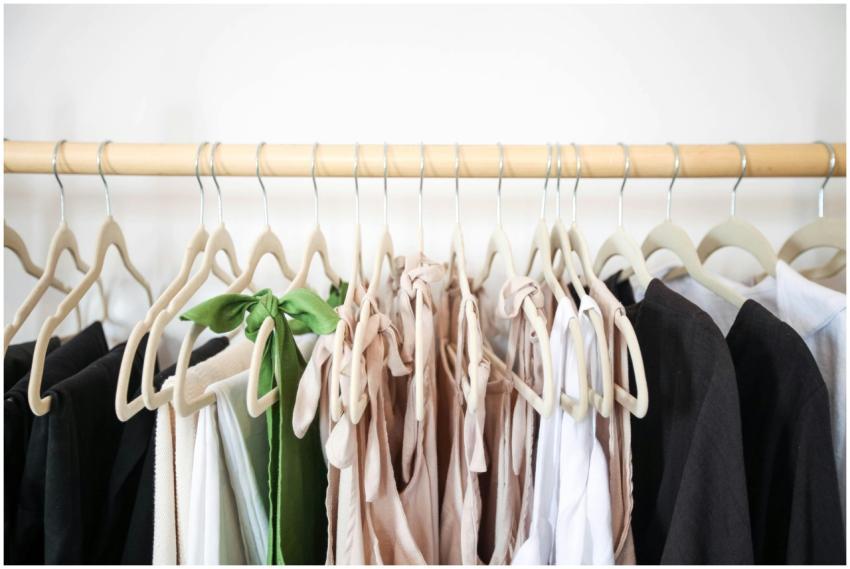 Stylish clothes beautifully arranged on a wooden h