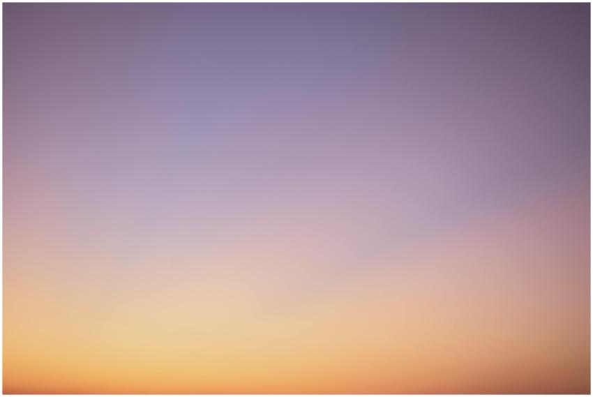 A serene gradient sky with hues of blue, pink, and