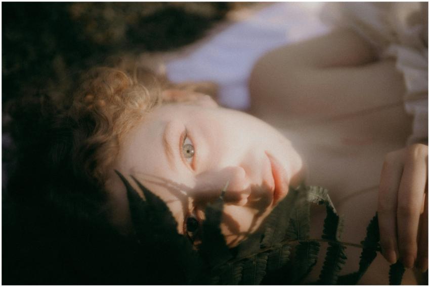 Soft-focus close-up portrait of a woman lying with