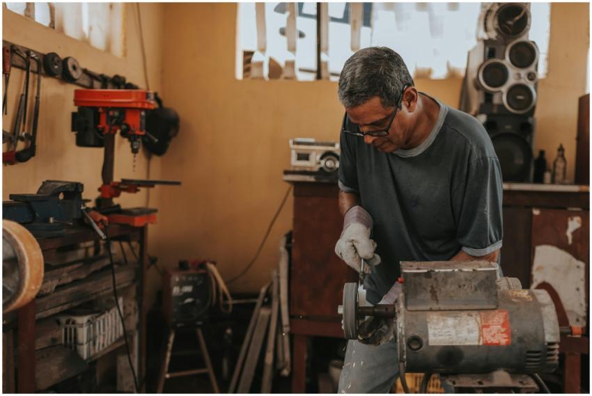 A skilled artisan focuses on metalwork with precis