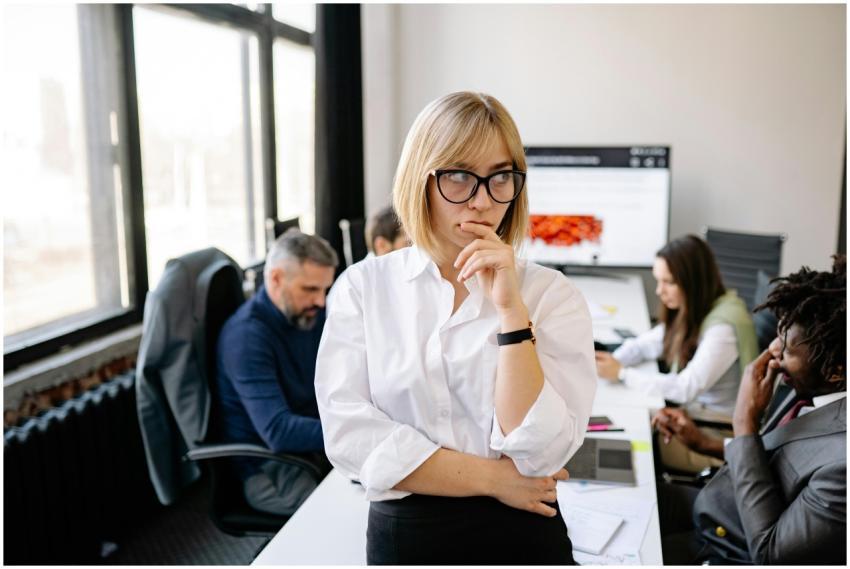 A focused businesswoman thinking during a team mee