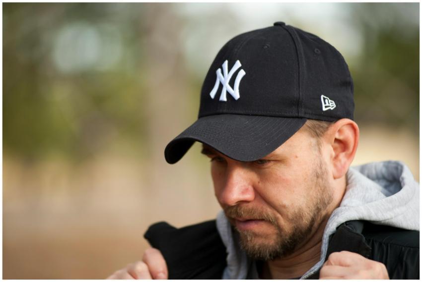 Close-up portrait of a man in a black New York Yan