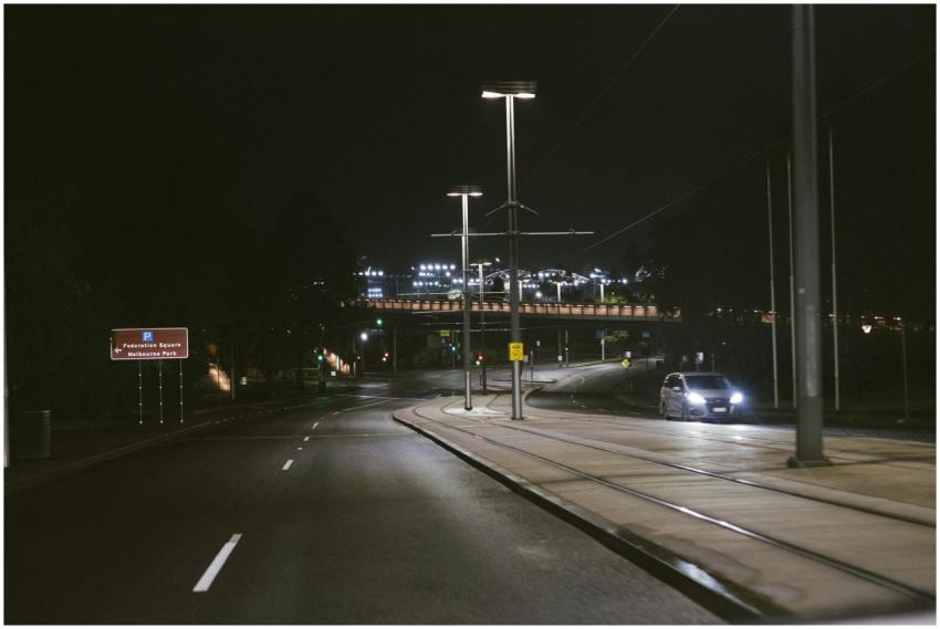 Night view of a road in Melbourne, featuring car h