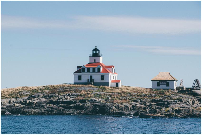 Charming lighthouse on a rocky seashore, ideal for