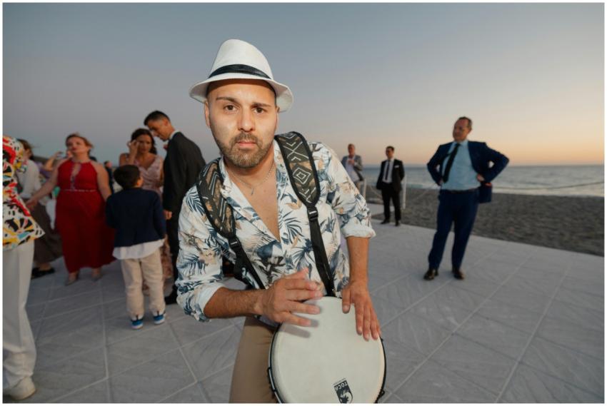 A lively beachside party with a drummer and elegan