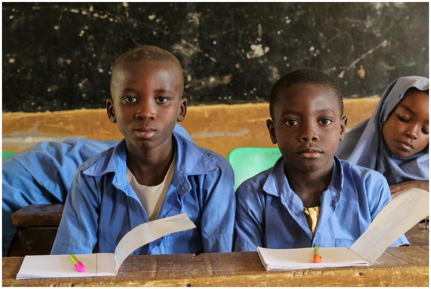 Children in a rural classroom setting focused on t