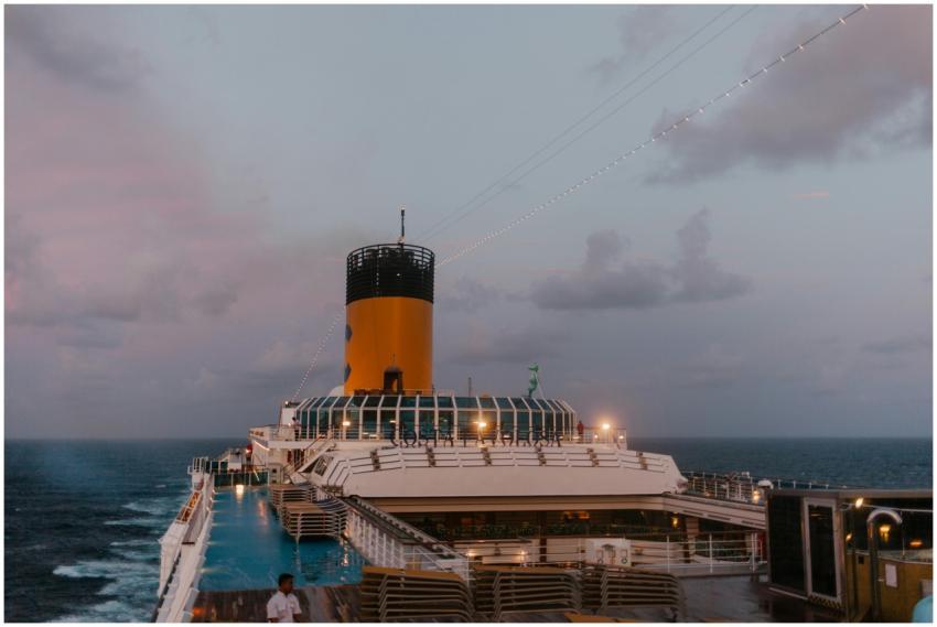 A cruise ship sails peacefully at twilight, with a