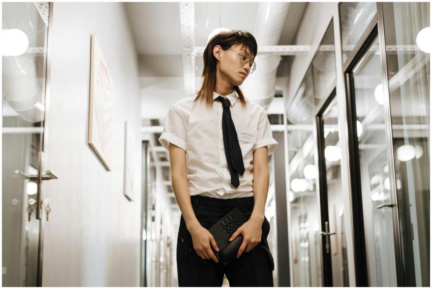 Young professional standing in a modern office hal