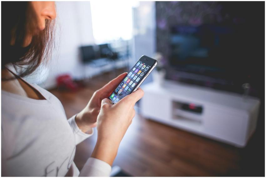 Woman browsing smartphone indoors, highlighting mo