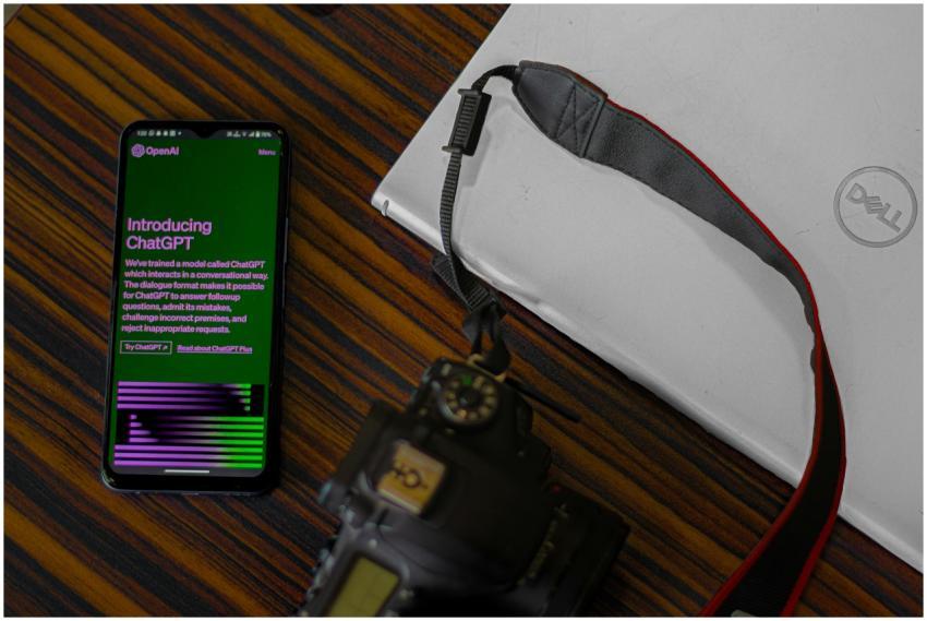 Smartphone with ChatGPT screen next to camera and