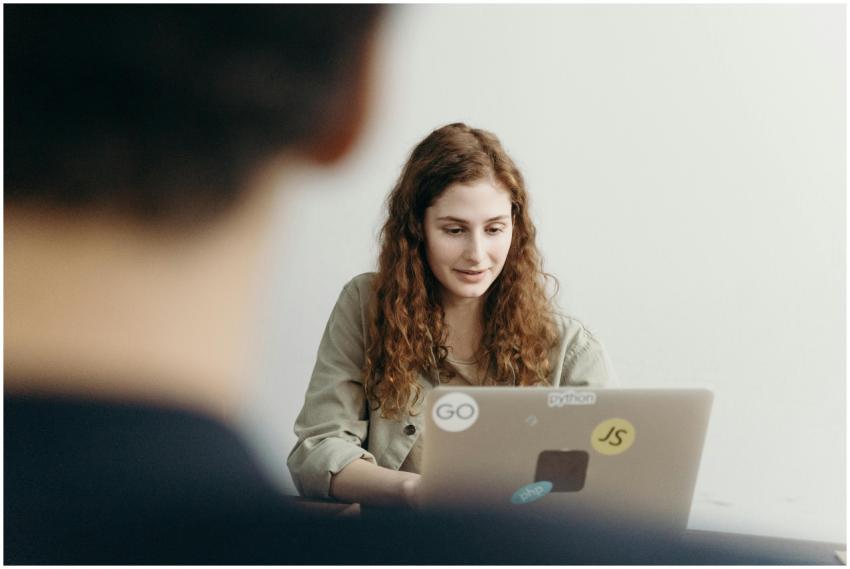 Young professional woman working on a laptop in an