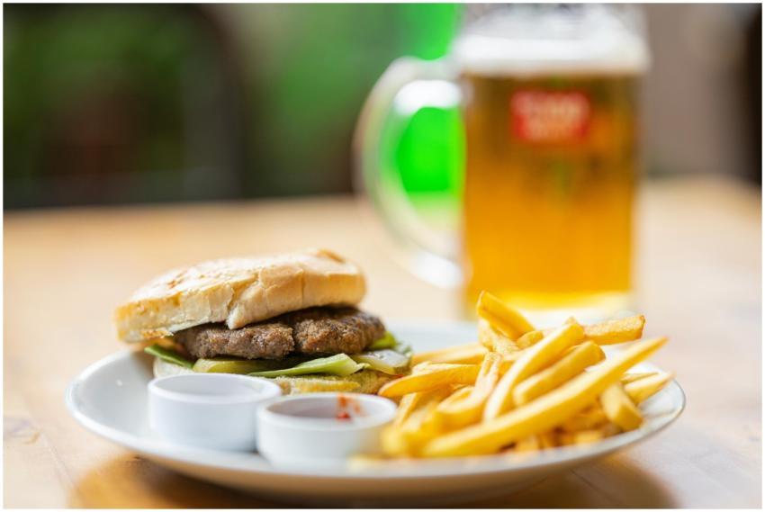 Delicious cheeseburger with fries and a beer, perf
