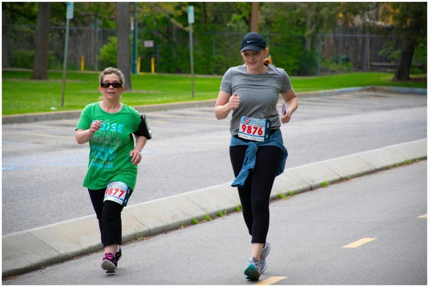 Two women jogging outdoors on a clear day, partici