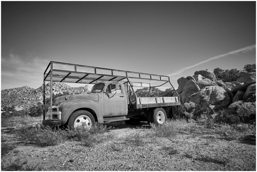 A classic vintage truck parked in a rugged desert