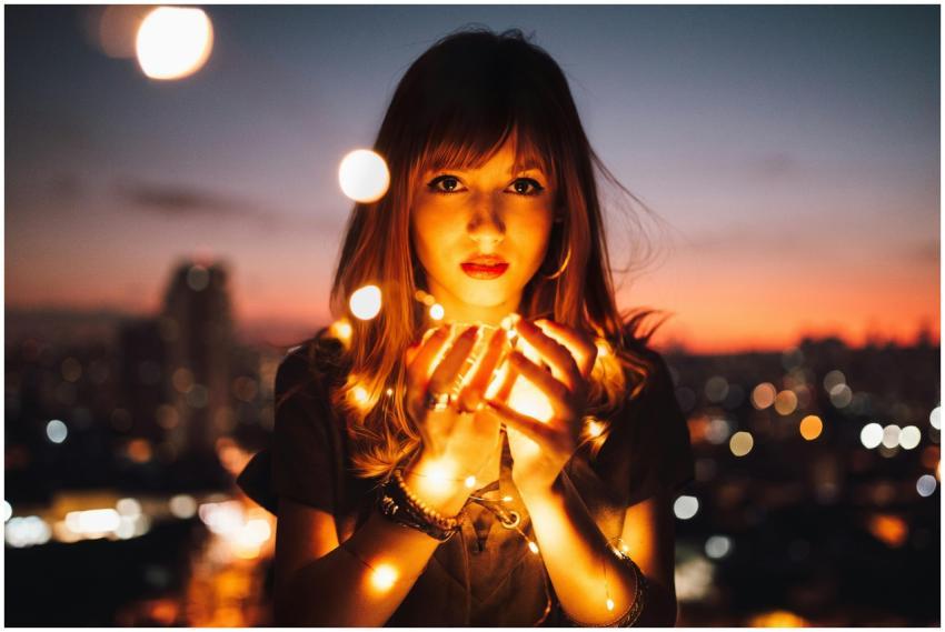 Romantic portrait of a woman holding glowing strin