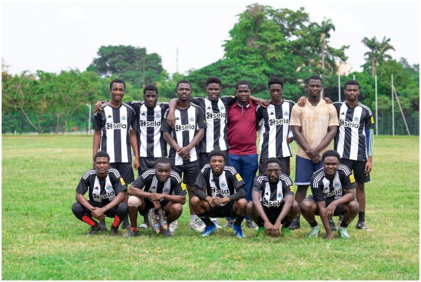 Youth soccer team in black and white jerseys posin