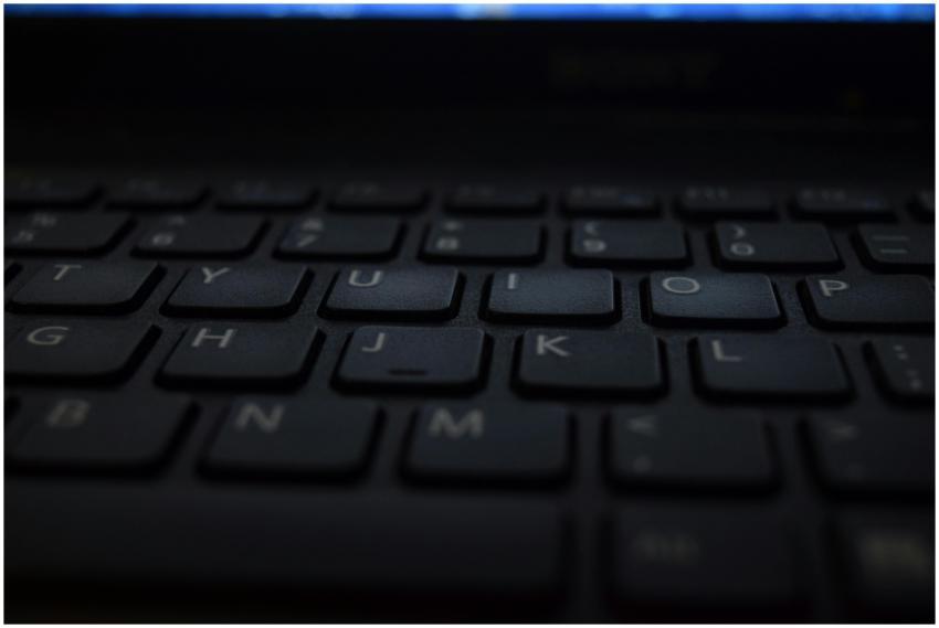 A close-up shot of a modern laptop keyboard with d