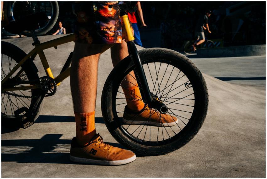 Dynamic view of a cyclist standing with a BMX bike
