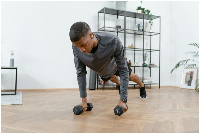 A man performing push-ups with dumbbells in a mode