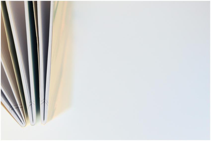 Top view of open notebooks on a white background,