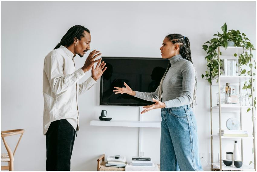 A young couple engaged in a tense argument in thei