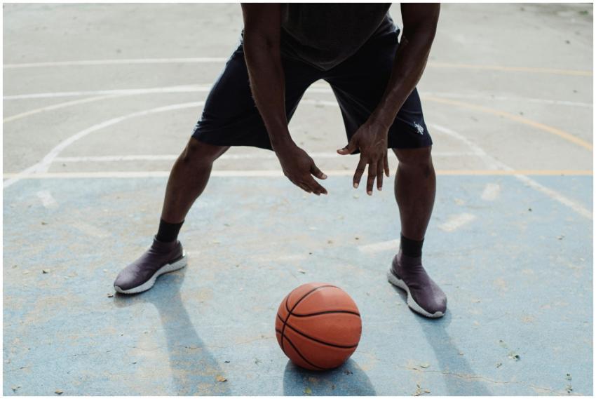An athletic man in action on an outdoor basketball