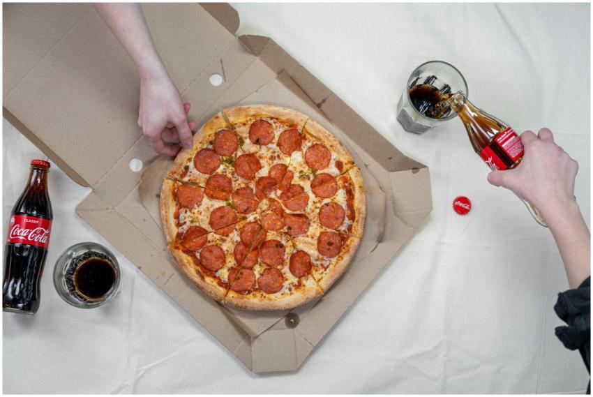 Enjoy a casual gathering with pizza and Coca Cola.