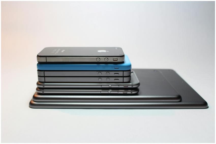 Stacked modern smartphones and tablets showcasing