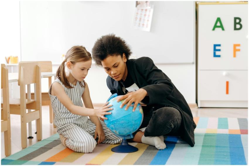 Two children engaged in learning with a globe in a