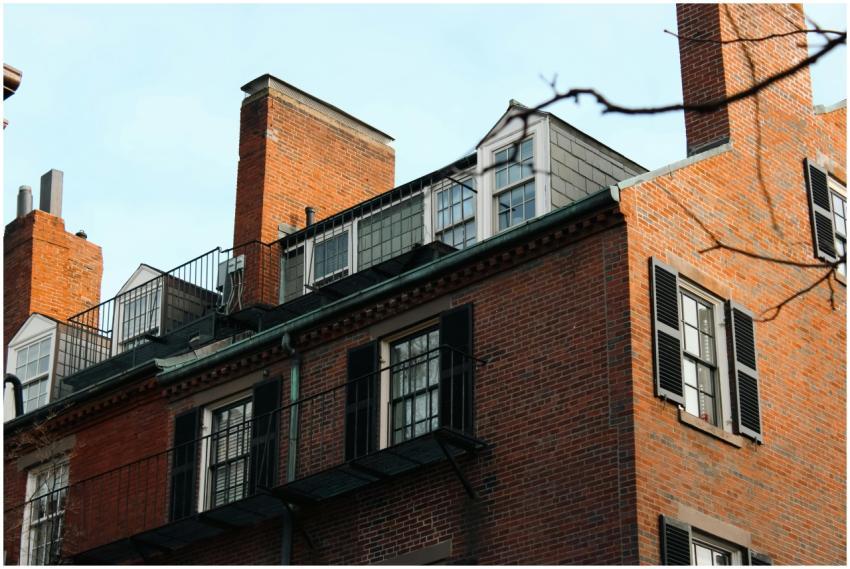Charming historic brick building with black shutte