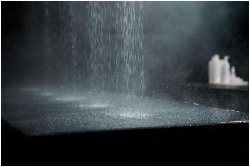 Artistic capture of water drops splashing on a dar