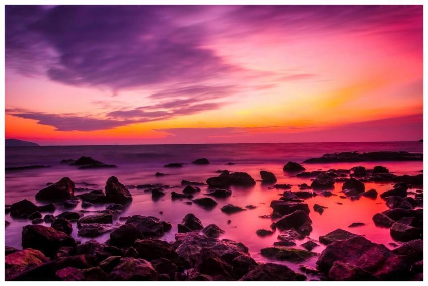 Beautiful seaside sunset with vibrant pink and ora