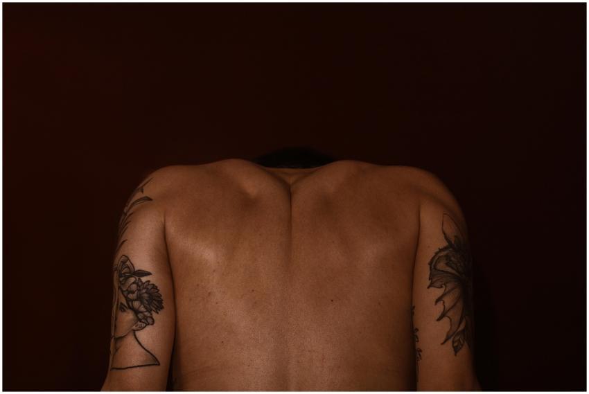 Artistic depiction of a tattooed man's back agains