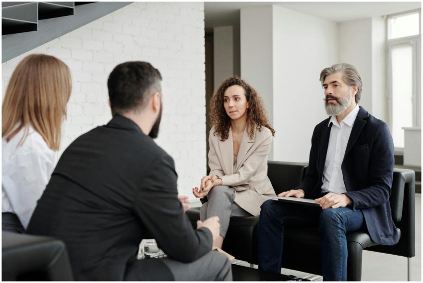 Four professionals engaged in a serious business d