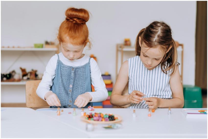 Two young girls actively engaged in a creative pro