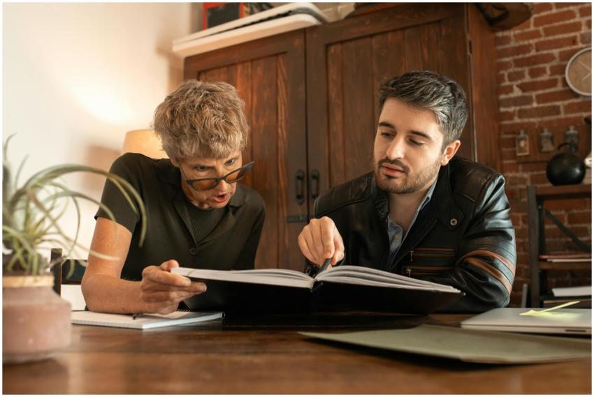 An elderly woman and a man study together in a coz