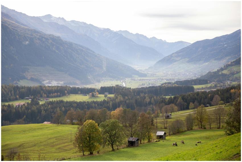 Beautiful mountain valley with green fields, scatt