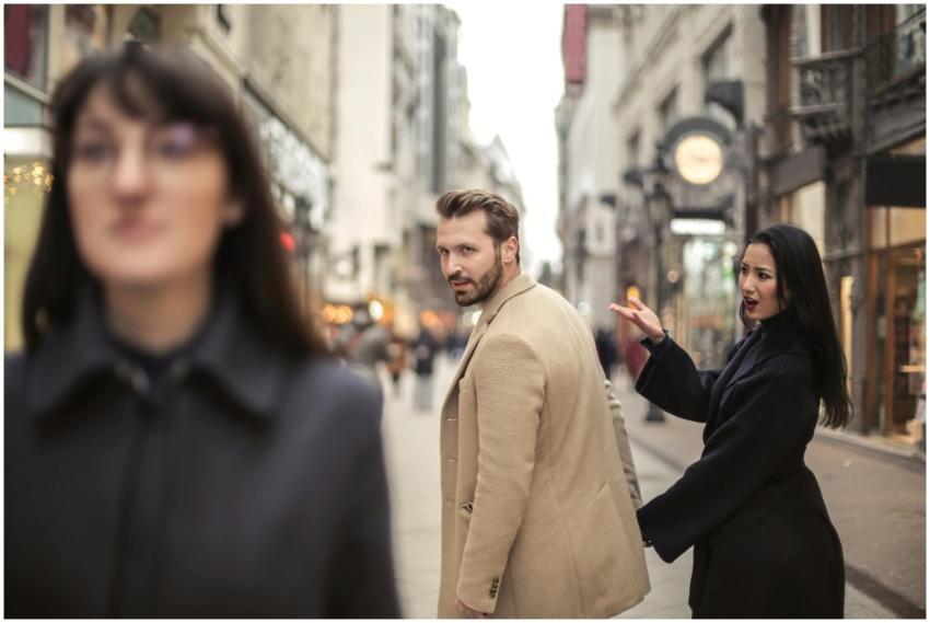 Man and woman in stylish attire on a vibrant city