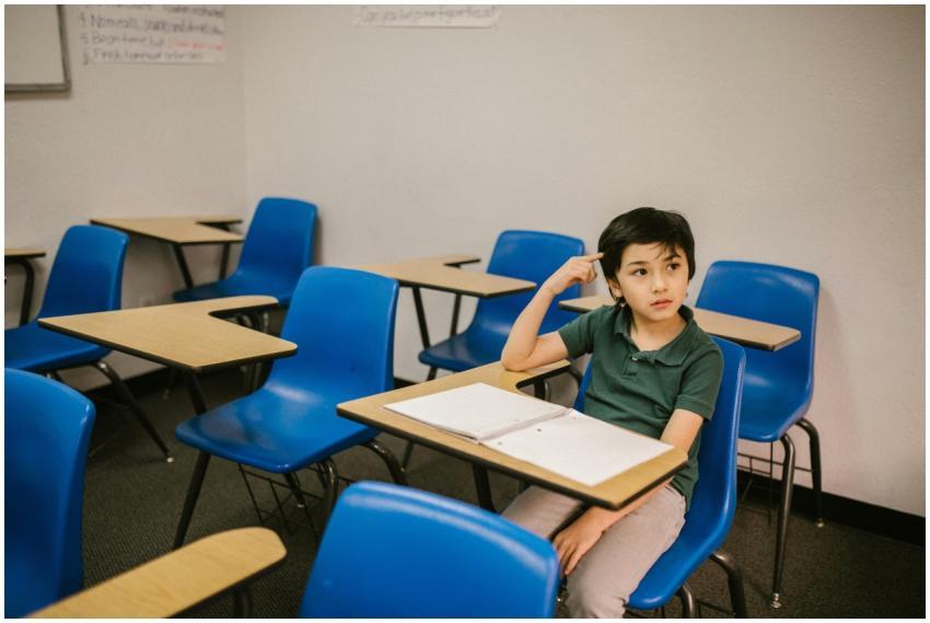 A young boy appears thoughtful while sitting alone